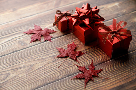Assorted artisanal gift boxes on wooden background. Christmas New year concept. Selective focus.の写真素材
