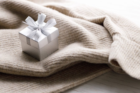 Artisanal gift boxes on warm sweater. Christmas New year concept. Selective focus.