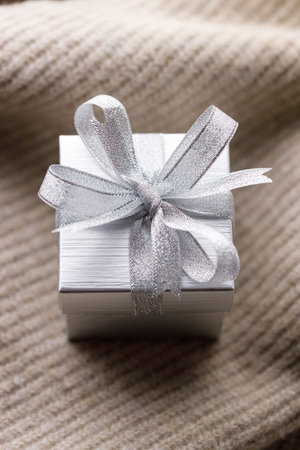 Artisanal gift boxes on warm sweater. Christmas New year concept. Selective focus.