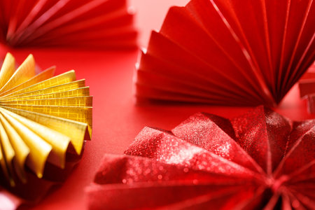Paper fans on red background for celebration Lunar New Year or Chinese New Year. Selective Focus.