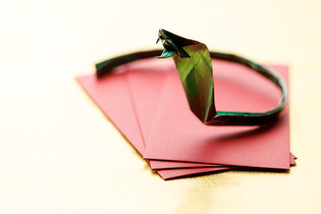 Paper snake, envelope on wooden background for celebration happy Lunar New Year or Chinese New Year. Selective Focus.の写真素材