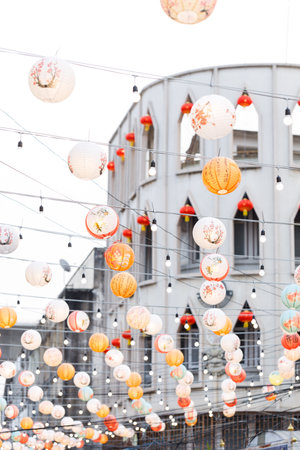 Lunar or Chinese new year lanterns decorated over street in old town, Thailand. The letters mean Luck, Congratulations, Blessing and Happinessの写真素材