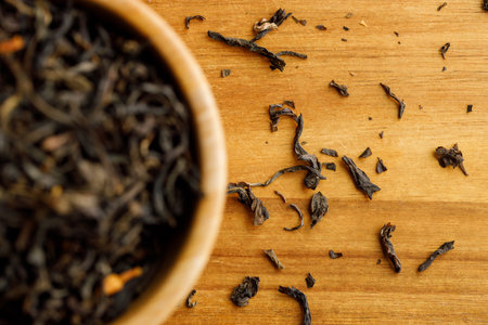 Japanese or Chinese jasmine tea leaf in wooden bowl on wooden background. selective focus.の写真素材