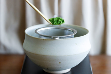 Closeup of fresh matcha powder, green tea powder, Chashaku, matcha scoop and Chawan, matcha bowl....