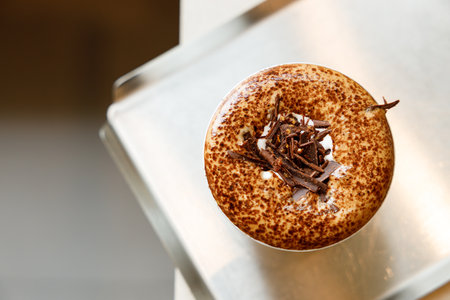 Cup of hot milk chocolate mocha coffee on table by the window. Selective focus.の写真素材