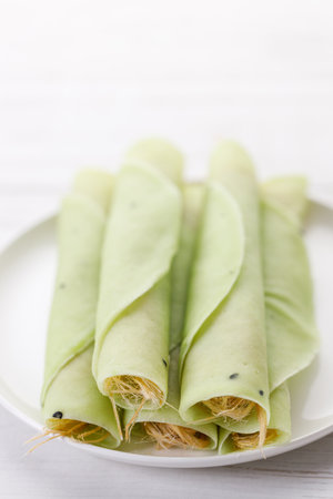 Roti Sai Mai, Dessert from Thailand served by wrapping cotton candy in sweet Roti or round flatbread. Selective focus.の写真素材