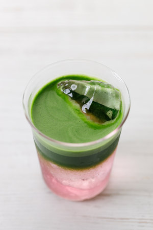 fresh matcha tea, green tea and coconut water on white wooden background. Selective focus.の写真素材