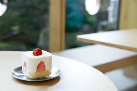 Piece of fresh delicious strawberry shortcake on wooden table. Selective focus.の写真素材