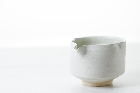 Cup of fresh matcha tea, green tea on white wooden table. Selective focus.の写真素材