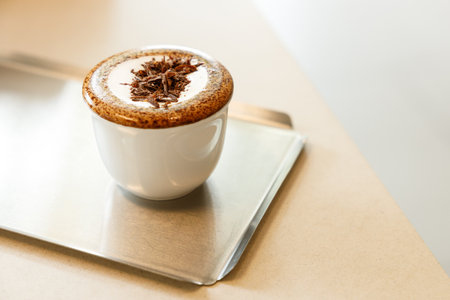 Cup of hot milk chocolate mocha coffee on table by the window. Selective focus.の写真素材