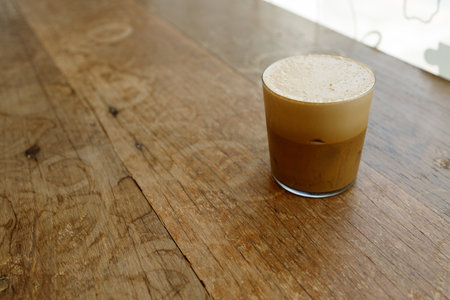 Cup of creation froth coffee on rustic wooden background. Selective focus. Copy space.の写真素材