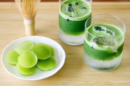Cup of fresh matcha tea, green tea with coconut water and Steamed Pandan Layer Cake, Thailand...