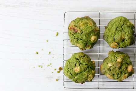 Closeup of fresh baked matcha cookies on white wooden background. Selective focus.の写真素材