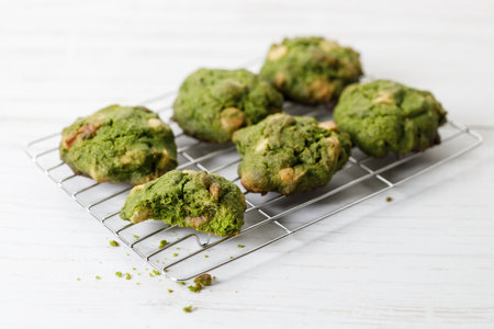 Closeup of fresh baked matcha cookies on white wooden background. Selective focus.の写真素材