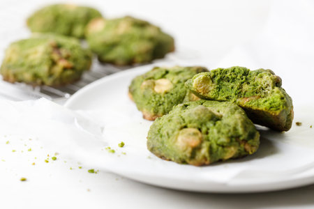 Closeup of fresh baked matcha cookies on white wooden background. Selective focus.の写真素材