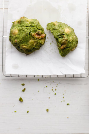 Closeup of fresh baked matcha cookies on white wooden background. Selective focus.の写真素材