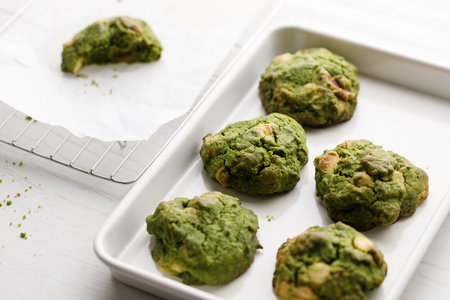 Closeup of fresh baked matcha cookies on white wooden background. Selective focus.の写真素材