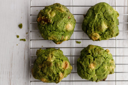 Closeup of fresh baked matcha cookies on white wooden background. Selective focus.の写真素材