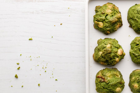Closeup of fresh baked matcha cookies on white wooden background. Selective focus.の写真素材
