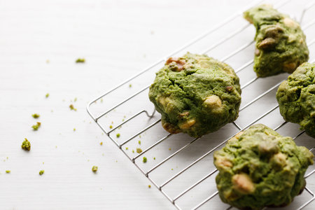 Closeup of fresh baked matcha cookies on white wooden background. Selective focus.の写真素材