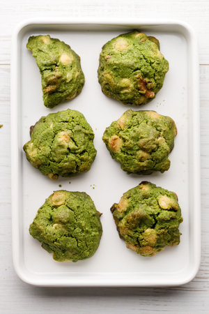 Closeup of fresh baked matcha cookies on white wooden background. Selective focus.の写真素材