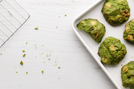Closeup of fresh baked matcha cookies on white wooden background. Selective focus.の写真素材