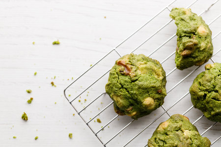 Closeup of fresh baked matcha cookies on white wooden background. Selective focus.の写真素材