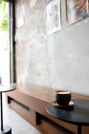 Cup of milk piccolo latte coffee on table by the street. Selective focus.