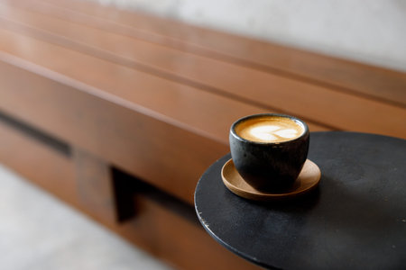Cup of milk piccolo latte coffee on table by the street. Selective focus.