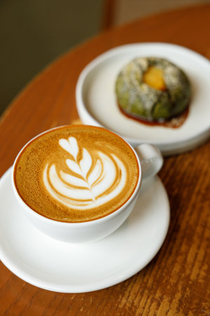 Cup of hot milk latte coffee on table by the window. Selective focus.の写真素材