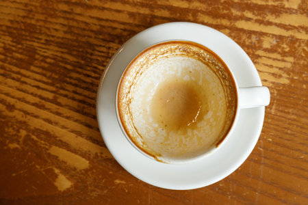 Empty cup of hot milk latte coffee on table by the window. Selective focus.の写真素材