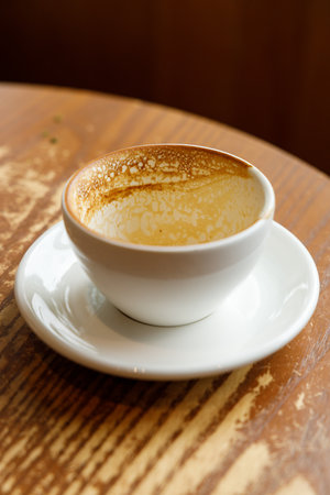 Empty cup of hot milk latte coffee on table by the window. Selective focus.の写真素材