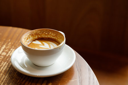 Cup of hot milk latte coffee on table by the window. Selective focus.の写真素材