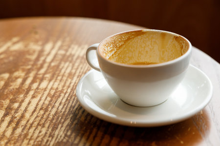 Empty cup of hot milk latte coffee on table by the window. Selective focus.の写真素材