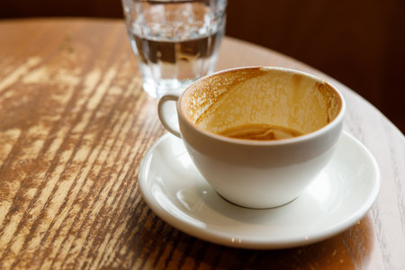 Empty cup of hot milk latte coffee on table by the window. Selective focus.の写真素材