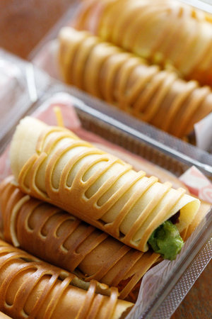 Stack of pancake roll filled with assorted filling. Selective focus.の写真素材