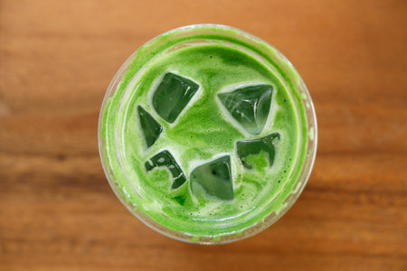 Cup of fresh matcha tea, green tea on wooden mat background. Selective focus.の写真素材