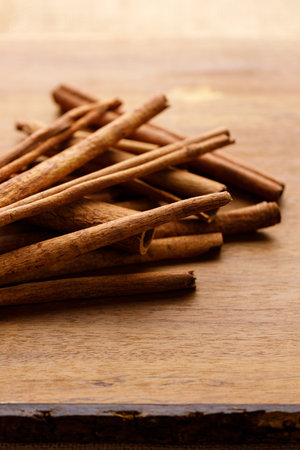 Cinnamon sticks dried tree bark spice on rustic wooden table background. Selective focus.の写真素材