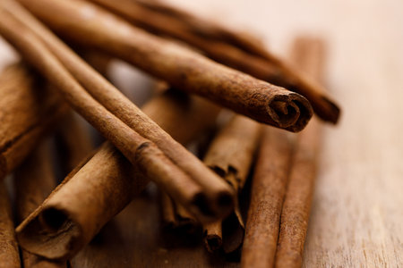 Cinnamon sticks dried tree bark spice on rustic wooden table background. Selective focus.の写真素材