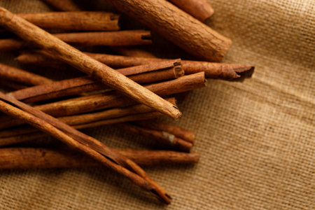 Cinnamon sticks dried tree bark spice on rustic background. Selective focus.