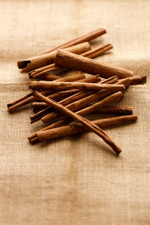 Cinnamon sticks dried tree bark spice on rustic background. Selective focus.の写真素材