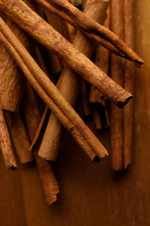 Cinnamon sticks dried tree bark spice on rustic wooden table background. Selective focus.の写真素材