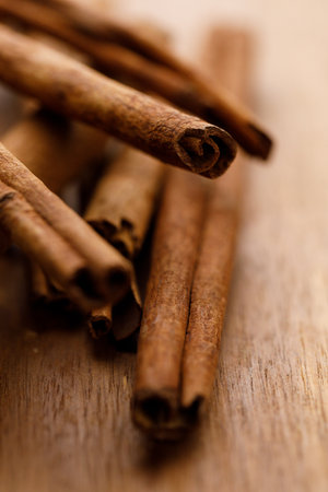 Cinnamon sticks dried tree bark spice on rustic wooden table background. Selective focus.の写真素材