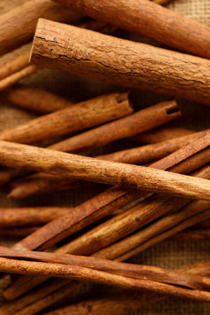 Cinnamon sticks dried tree bark spice on rustic background. Selective focus.