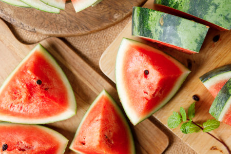 Slices of fresh watermelon on rustic wooden background. Selective focus.の写真素材