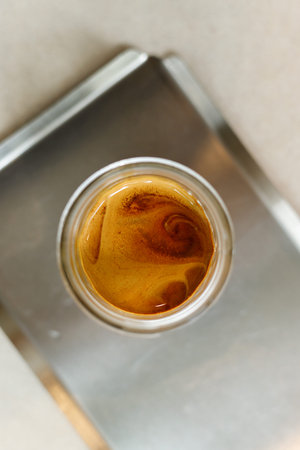 Cup of chilled milk coffee on table by the window. Selective focus.