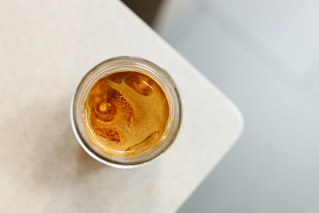 Cup of milk coffee on table by the window. Selective focus.の写真素材