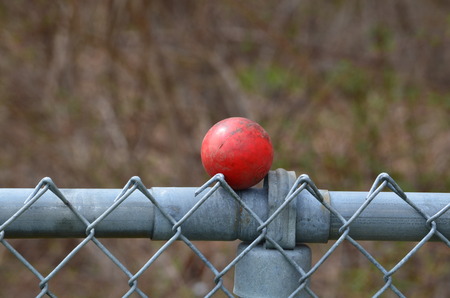 Red ball on a fenceの写真素材