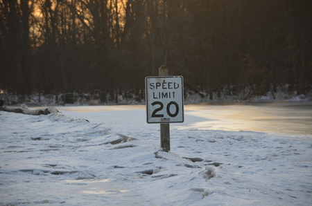 A speed limit sign stuck in a ice jamの写真素材