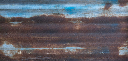 Blue metal corrugated panel with a lot of rust.